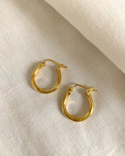 Load image into Gallery viewer, A gold oval chunky hoop earrings set in 14k gold.
